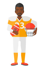 Rugby player with ball and helmet in hands.