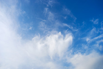 Blue sky with clouds on a summer day .