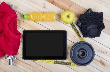 Sport Equipment. Barbell, Weight, Gloves, Red Shirt, Orange Juice, Apple,  Tape Measure And Tablet To Workout Plan On Wooden Boards. Sport Fitness Background