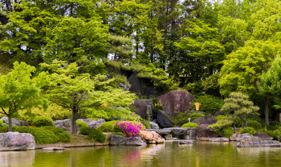 Fototapeta na wymiar Waterfall, Pond, Reflection, green Colors, japanese garden