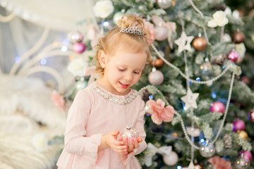 the little girl near a Christmas fir-tree