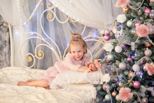 the little girl near a Christmas fir-tree