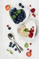 Healthy breakfast of muesli, berries with yogurt and seeds