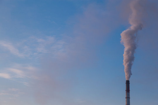 Industrial smoke stack with large white smoke cloud