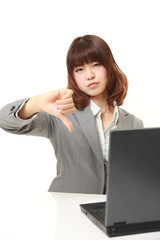 young Japanese businesswoman with thumbs down gesture