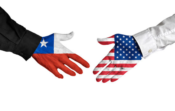 Chile and United States leaders shaking hands on a deal agreement
