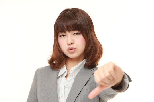 young Japanese businesswoman with thumbs down gesture
