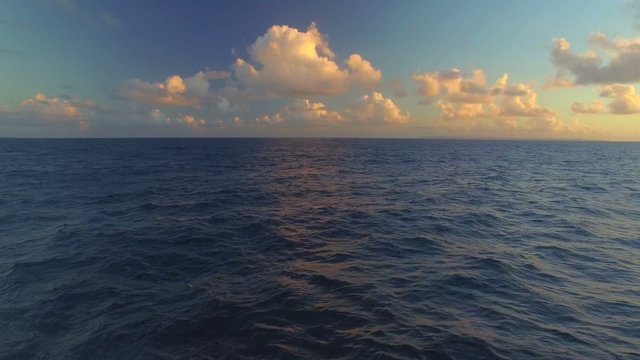 Caribbean sea and waves at sunset, view from boat