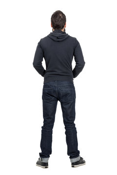 Rear View Of Man In Black Hooded Shirt With Rolled Up Jeans. Full Body Length Portrait Isolated Over White Studio Background.