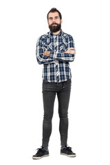 Fototapeta premium Confident bearded man with crossed arms in tartan plaid shirt looking at camera. Full body length portrait isolated over white studio background.