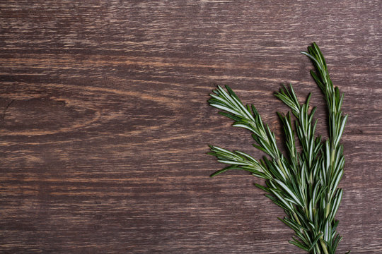 Rosemary on a wooden background close-up