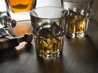 Whiskey on the rocks on a wooden table