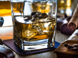 Whiskey on the rocks on a wooden table