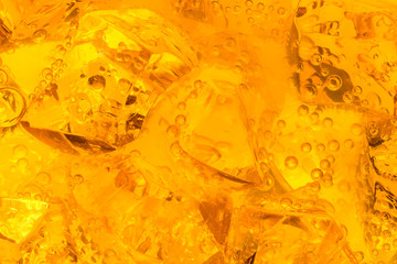 Close-up of ice cubes in orange juice
