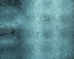Small frosty patterns on glass in gray-blue tone