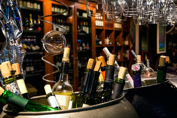 Wine in the bottles closed by traffic jams against wooden brown wine racks