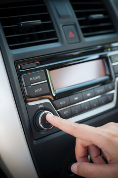 Driver Finger Pushing Button Of Car Audio Player.