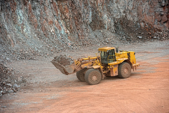 excavator loading stones in a quarry. mining industry