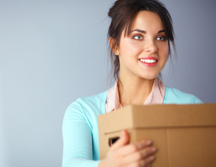 Portrait of pretty woman holding a box 