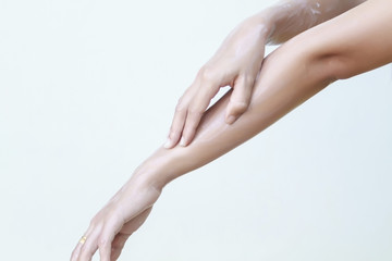 A beautiful woman asia using a skin care product, moisturizer or lotion and Skincare taking care of her dry complexion. Moisturizing cream in female hands 