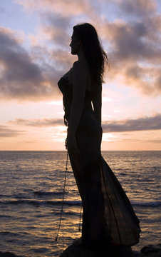 Romantic silhoette of the girl against a sea decline