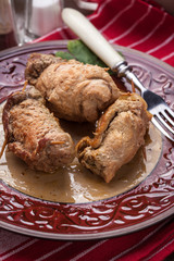 Rolls pork on the plate.