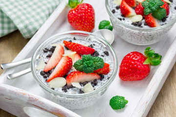 Chia seed pudding with strawberries, almond and chocolate cookie crumbs