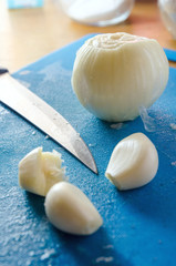 Minced garlic on a cutting board on a background of chef knife