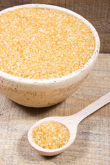 Brown sugar cane on the wooden background.