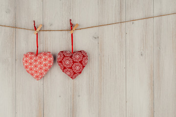 Heart hanging on the clothesline. On old wood background