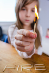 A Young Girl Playing With Matches
