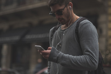 Fashionable man working on his phone in the coffee shop