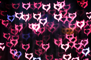 Blurring lights bokeh background of Devil hearts