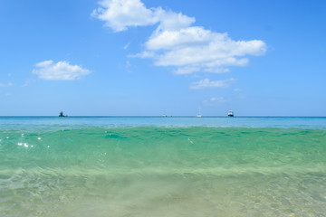 Fototapeta na wymiar Clear sea water with blue sky , Layan beach Phuket in Thailand