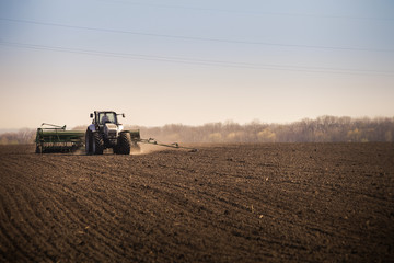 Naklejka premium panorama of operating tractor in field