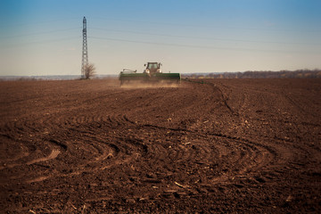 panorama of tractor sowing in field