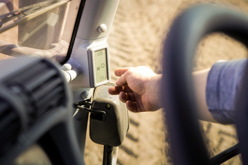 closeup man points to display screen through steering-wheel