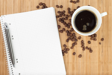 Obraz na płótnie Canvas Empty exercise book with coffee