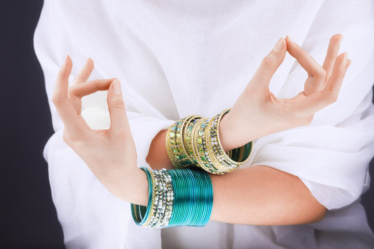Girl hands with golden bracelets
