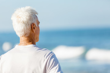 Fototapeta premium Man standing on beach in sports wear
