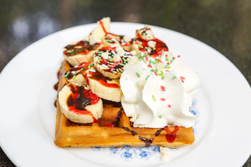 Waffle with banana slices and cream