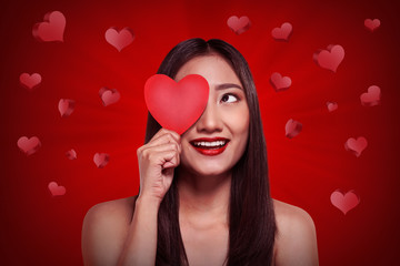 Beautiful chinese woman holding red heart