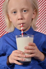 boy drinking milk with a straw