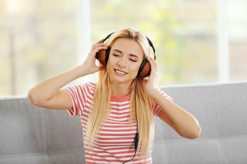 Young woman on a sofa listening to music