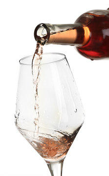 Rose Wine Pouring In Glass, Isolated On White