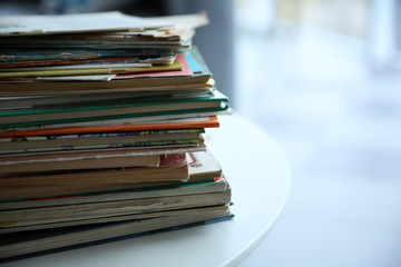 Pile of old books on white table