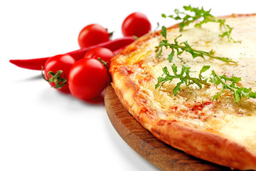 Pizza full of cheese on wooden board with vegetables isolated on white background, close up