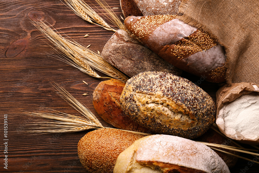 Wall mural Fresh baked bread on the wooden background