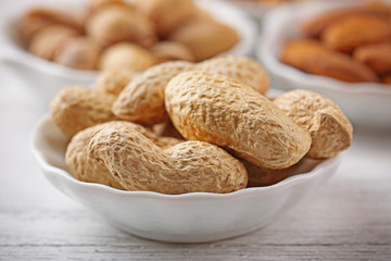 Peanuts, pistachios and almonds in the bowls, close-up