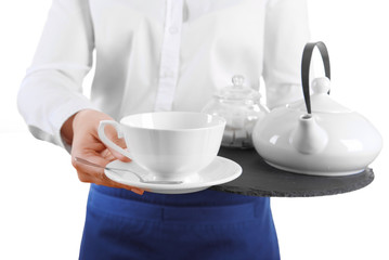 Waiter holding tray with cup and teapot on white background